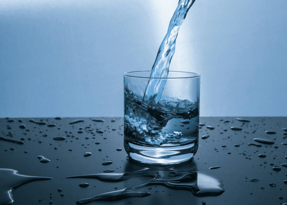 A glass of water being poured – hydration is crucial for all bodily functions